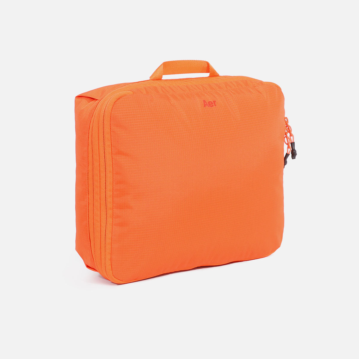Aer Packing Cube product image - AER29052 packingcube safetyorange 34hero