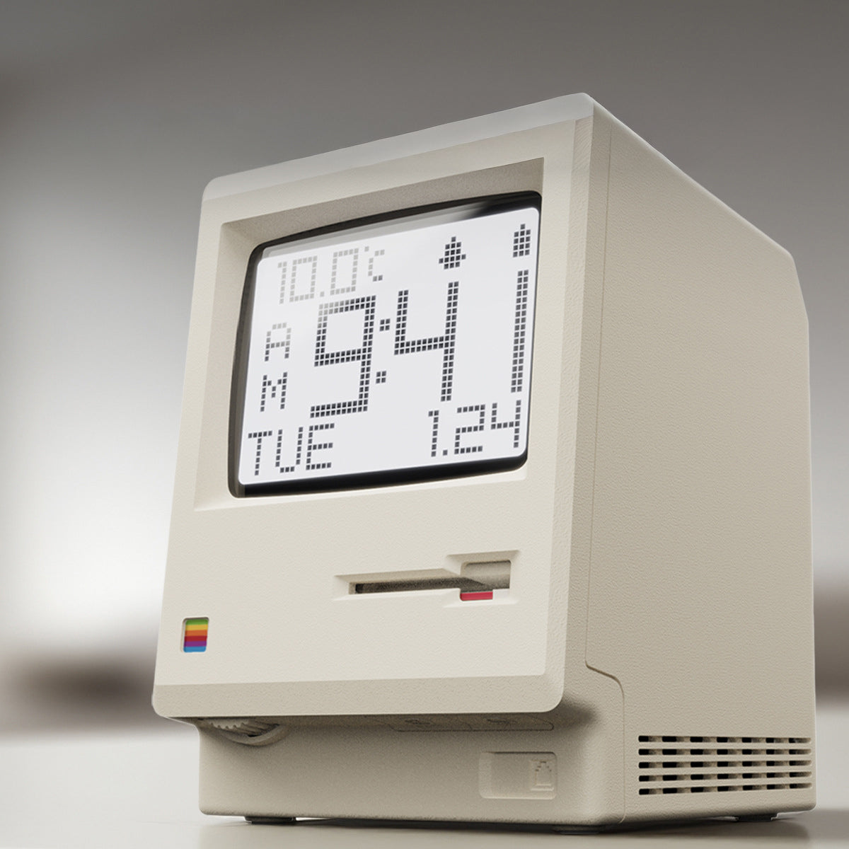 Hand holding the Retro Macintosh Clock digital alarm clock with a digital display showing time, date, and temperature